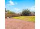 Large backyard with a mix of grass and gravel, enclosed by a block wall for privacy at 3227 E Enid Ave, Mesa, AZ 85204