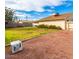 Expansive backyard with lawn and gravel area, perfect for outdoor activities and relaxation at 3227 E Enid Ave, Mesa, AZ 85204