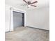 Simple bedroom with carpet flooring and an open closet at 3227 E Enid Ave, Mesa, AZ 85204