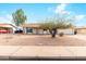 Charming single-story home features a low maintenance front yard and a two car garage at 3227 E Enid Ave, Mesa, AZ 85204