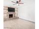 Living room with fireplace, tv, and wood-look laminate floors at 3227 E Enid Ave, Mesa, AZ 85204