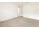 An open and airy bedroom with neutral carpet, a closet, and white walls at 3598 E Alexander Dr, San Tan Valley, AZ 85143