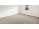 A wide bedroom with neutral carpet, white walls, and a window at 3598 E Alexander Dr, San Tan Valley, AZ 85143