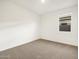 This bedroom features neutral carpet, a window and white walls at 3598 E Alexander Dr, San Tan Valley, AZ 85143