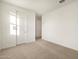 Well-lit bedroom with neutral carpet, closet and bright white doors at 3598 E Alexander Dr, San Tan Valley, AZ 85143