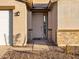 Inviting covered front porch with stone accents and a charming front door at 3598 E Alexander Dr, San Tan Valley, AZ 85143