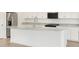 Kitchen island with stainless steel sink and white cabinets at 3598 E Alexander Dr, San Tan Valley, AZ 85143
