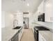 Bright kitchen featuring white cabinets, stainless steel appliances, and granite countertops at 3598 E Alexander Dr, San Tan Valley, AZ 85143