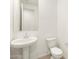Powder room featuring a pedestal sink and toilet with tile flooring at 3598 E Alexander Dr, San Tan Valley, AZ 85143