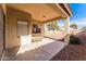 Covered back patio overlooking the rock and brick landscaping at 44922 W Alamendras St, Maricopa, AZ 85139