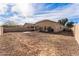 View of the backyard featuring brick patio, rock, and block perimeter fence at 44922 W Alamendras St, Maricopa, AZ 85139