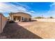 View of the backyard with a brick patio and rock landscaping at 44922 W Alamendras St, Maricopa, AZ 85139
