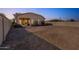 Backyard featuring rock landscaping and perimeter block fencing at 44922 W Alamendras St, Maricopa, AZ 85139