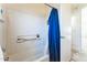 Bathroom featuring a tub and shower with blue curtain at 44922 W Alamendras St, Maricopa, AZ 85139