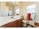 Bathroom featuring single sink vanity and a well-lit mirror at 44922 W Alamendras St, Maricopa, AZ 85139