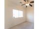 Bright bedroom features a ceiling fan and a large window, great natural light at 44922 W Alamendras St, Maricopa, AZ 85139
