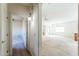 Wide hallway leading into an open, bright living space and kitchen at 44922 W Alamendras St, Maricopa, AZ 85139
