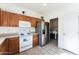 Kitchen featuring wood cabinets, stainless steel refrigerator, and modern appliances at 44922 W Alamendras St, Maricopa, AZ 85139