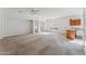Spacious living room area with carpet flooring and natural light at 44922 W Alamendras St, Maricopa, AZ 85139