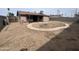 Large backyard with a fire pit and block-wall fencing at 4537 E Hidalgo Ave, Phoenix, AZ 85040