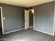 Bedroom with neutral walls, carpet, and a view into an open doorway at 4537 E Hidalgo Ave, Phoenix, AZ 85040