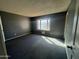 Bedroom with black carpet and natural lighting at 4537 E Hidalgo Ave, Phoenix, AZ 85040