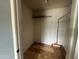 Walk-in closet with parquet flooring, hanging racks, and built-in shelving at 4537 E Hidalgo Ave, Phoenix, AZ 85040
