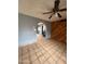 Comfortable living room showing wood paneling, ceiling fan, and tile flooring at 4537 E Hidalgo Ave, Phoenix, AZ 85040