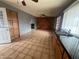 An expansive living area featuring wood paneling, tile floors, and abundant natural light at 4537 E Hidalgo Ave, Phoenix, AZ 85040