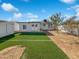 Spacious backyard with lush synthetic lawn and privacy fence, perfect for outdoor activities at 4644 E Southern Ave, Phoenix, AZ 85042
