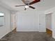 Bedroom featuring a ceiling fan, neutral carpet, and a closet for ample storage at 4644 E Southern Ave, Phoenix, AZ 85042