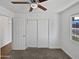 Bedroom featuring a ceiling fan, neutral carpet, and a closet for ample storage at 4644 E Southern Ave, Phoenix, AZ 85042