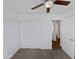Bedroom featuring a ceiling fan, neutral carpet, and a closet for ample storage at 4644 E Southern Ave, Phoenix, AZ 85042