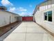 Concrete driveway with red gate and white walls on both sides at 4644 E Southern Ave, Phoenix, AZ 85042
