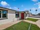 Close up of the exterior of a freshly painted home with a manicured lawn and inviting entryway at 4644 E Southern Ave, Phoenix, AZ 85042