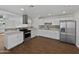 Updated kitchen with stainless steel appliances, granite countertops, and ample cabinet space at 4644 E Southern Ave, Phoenix, AZ 85042
