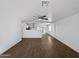 Open-concept living space showcasing hardwood floors, a ceiling fan, and views into the kitchen at 4644 E Southern Ave, Phoenix, AZ 85042