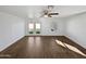Open living room with fan, and double doors leading to a bright backyard space at 4644 E Southern Ave, Phoenix, AZ 85042
