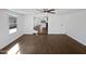 Spacious living room with dark wood-look floors and an open view into the kitchen at 4644 E Southern Ave, Phoenix, AZ 85042