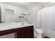 Well-lit bathroom with a white vanity, large mirror, shower, and toilet at 4744 E Tierra Buena Ln, Phoenix, AZ 85032