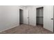 A cozy bedroom with plush carpet, with an entrance and walk-in closet for convenient storage at 4744 E Tierra Buena Ln, Phoenix, AZ 85032