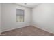 A bright bedroom with neutral walls and carpet, offering a comfortable and inviting atmosphere at 4744 E Tierra Buena Ln, Phoenix, AZ 85032