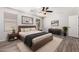 Staged bedroom features wood-look floors, a modern ceiling fan, and decorative artwork at 4744 E Tierra Buena Ln, Phoenix, AZ 85032