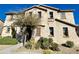 Charming two-story home with a stucco facade, landscaped yard, and mature trees at 4744 E Tierra Buena Ln, Phoenix, AZ 85032