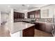 Spacious kitchen with large granite island, dark cabinetry, mosaic backsplash, and stainless appliances at 4744 E Tierra Buena Ln, Phoenix, AZ 85032