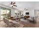 Bright living room with ceiling fans, large windows, and a dining area at 4744 E Tierra Buena Ln, Phoenix, AZ 85032