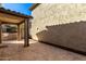 A covered patio offers shade with neutral colors and stone tiling in a backyard living space at 4744 E Tierra Buena Ln, Phoenix, AZ 85032