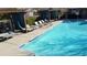 Beautiful community pool area with lounge chairs and shaded cabanas, ideal for relaxing and enjoying sunny days at 4744 E Tierra Buena Ln, Phoenix, AZ 85032
