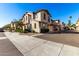 Well-maintained two-story townhomes line a street with sidewalks and lush green landscaping at 4744 E Tierra Buena Ln, Phoenix, AZ 85032