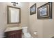 Charming powder room with granite vanity, framed mirror, and stylish decor at 5090 S Pinaleno Pl, Chandler, AZ 85249